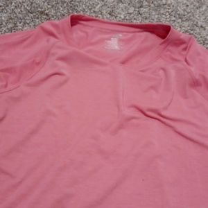 Pink short sleeve shirt with mesh at bottom